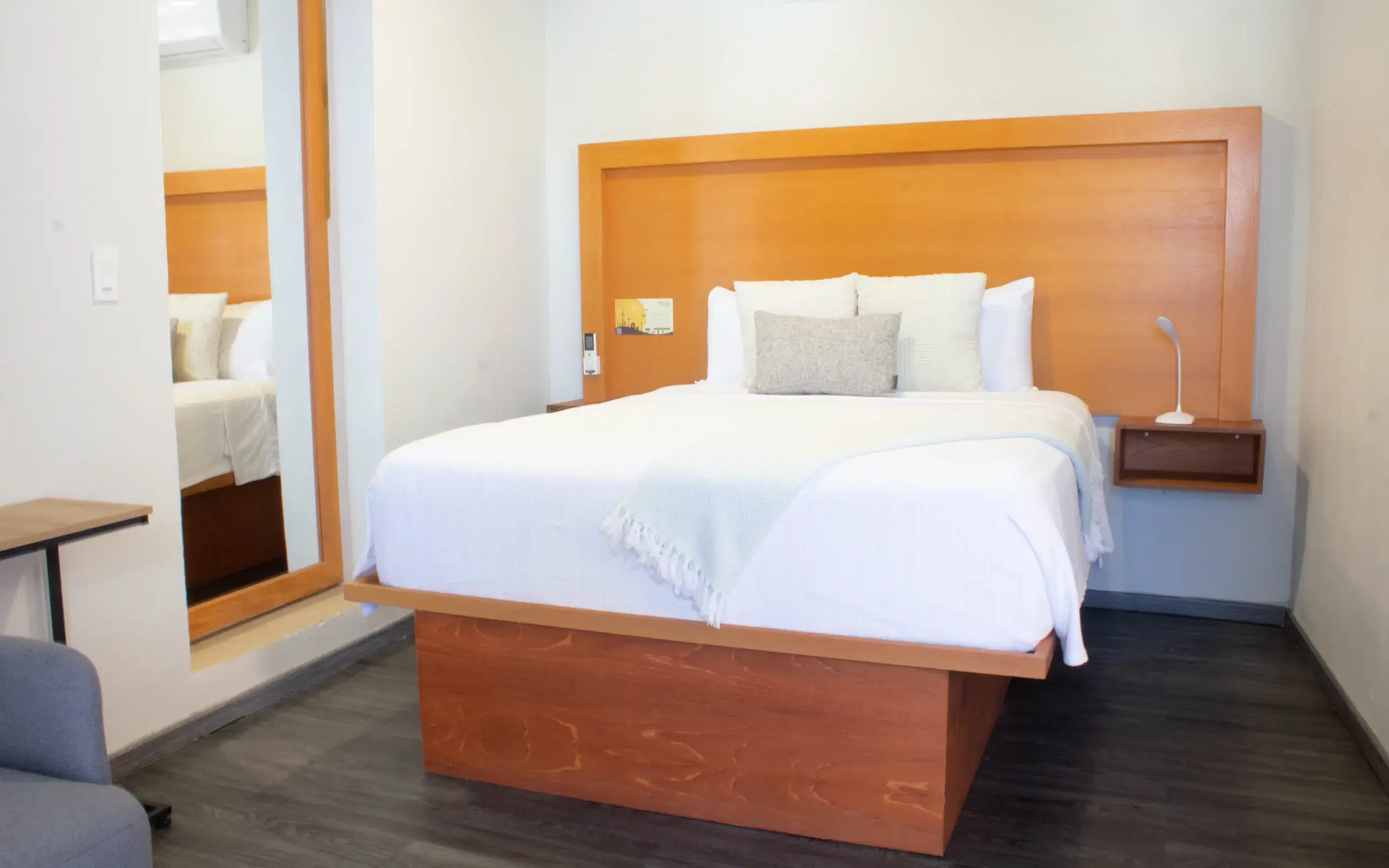 Standard Studio bedroom with wooden headboard
