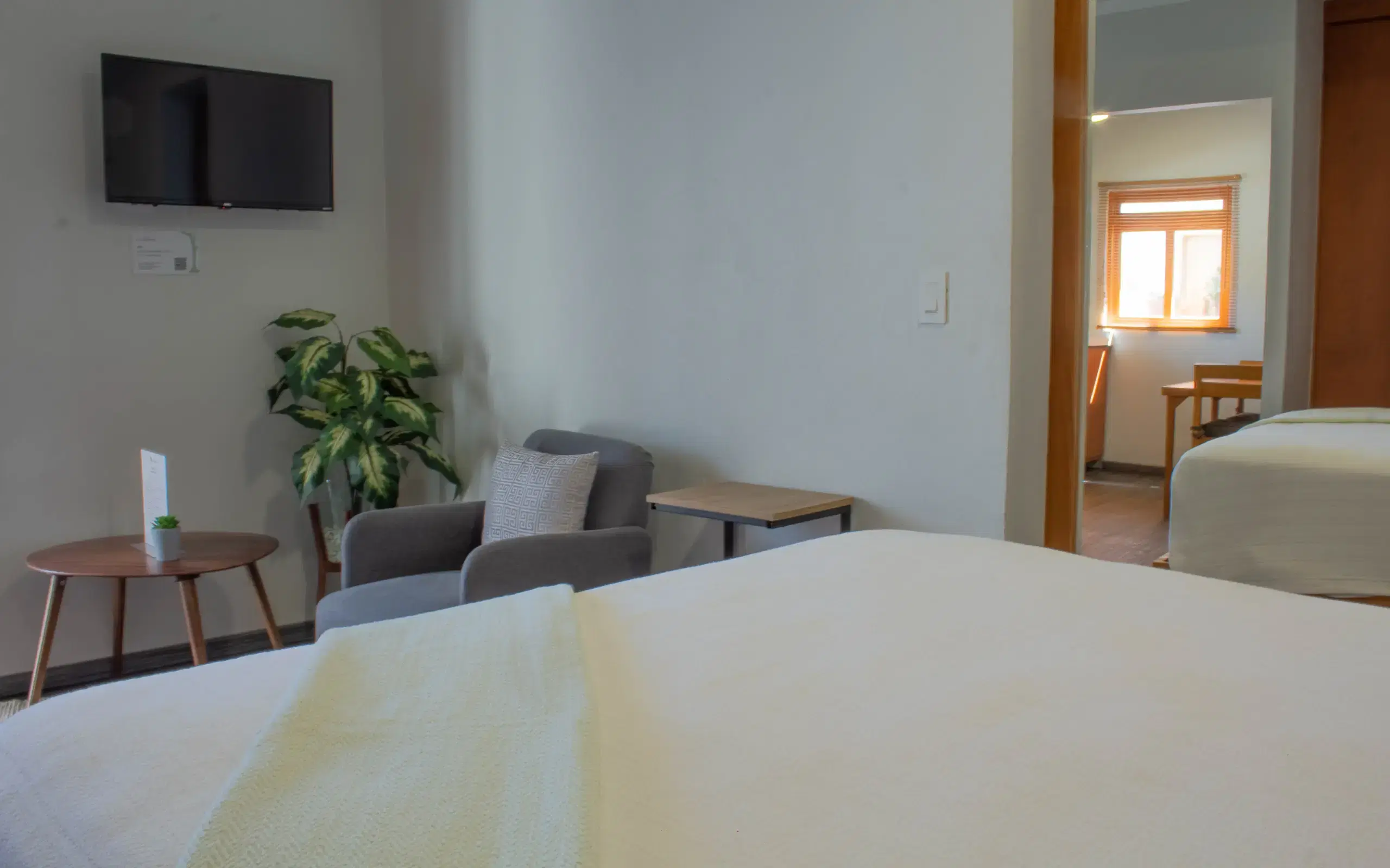 Standard Studio seating area with beds and doorway